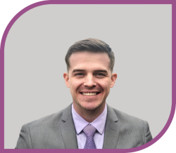 A man in a suit smiling.